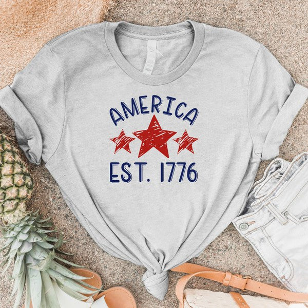 America EST 1776 crewneck soft style T-shirt -Wild Willows Boutique NY – Massapequa, New York. Affordable and fashionable clothing for women of all ages. Bottoms, tops, dresses, intimates, outerwear, sweaters, shoes, accessories, jewelry, activewear and more//wild Willow Boutique 